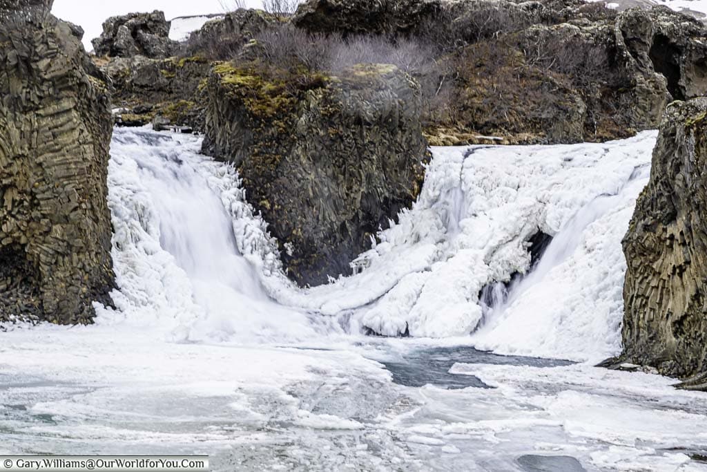 A close up of the twin frozen falls of Hjálparfoss in Iceland