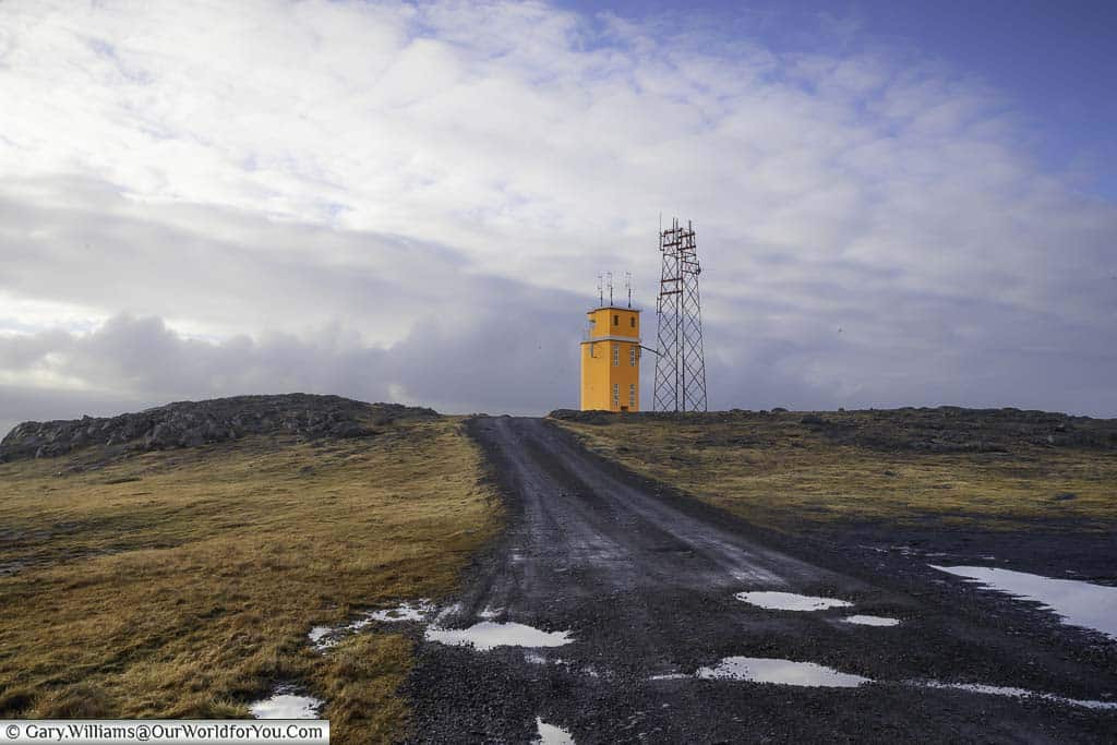 The orange Hvalnes lighthouse at the end of a dirt track in eastern Iceland