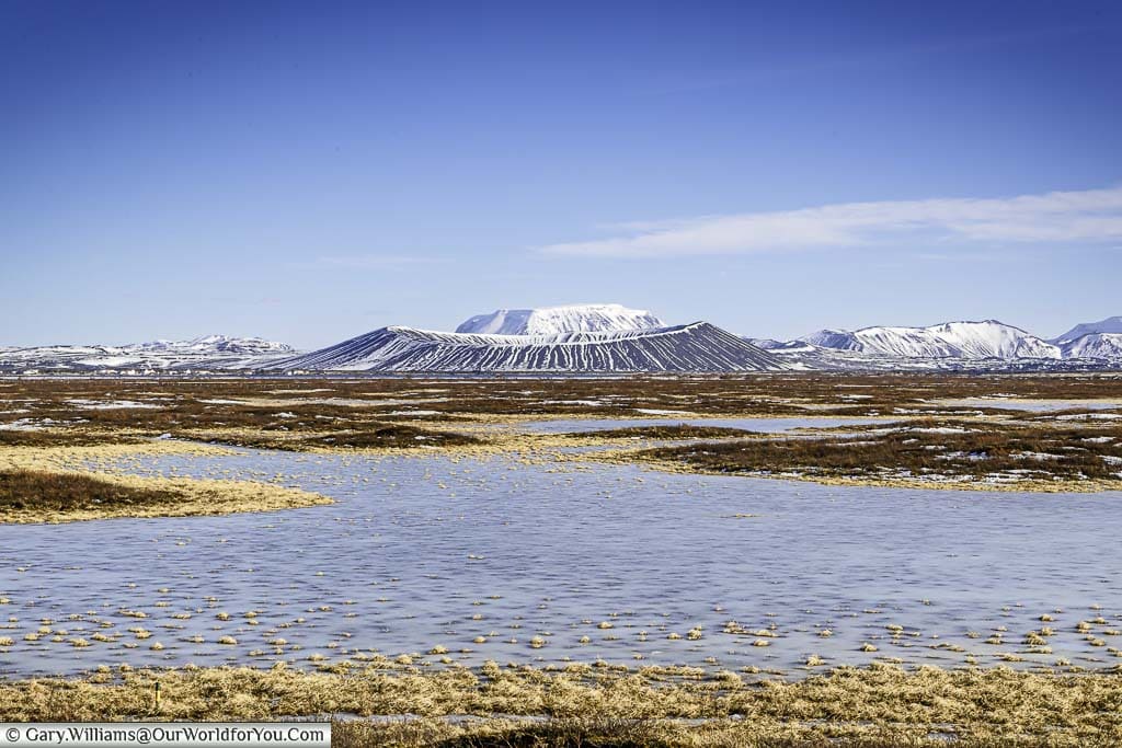 A view across thawed sections of Lake Myvatn to the Hverfjall Crater in the background