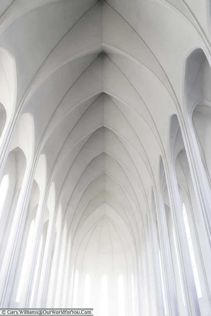 The plain white arched interior of iceland's most famous church, Hallgrímskirkja, in reykjavik