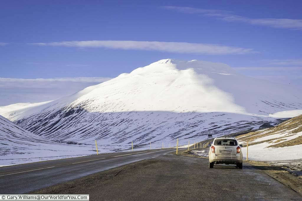 Our little 4x4 parked up in a layby off Iceland's Route Oneas it makes its way around snow-covered mountains