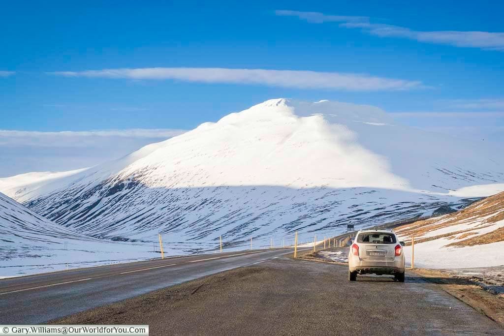 Our little 4x4 parked up in a layby off Iceland's Route Oneas it makes its way around snow-covered mountains