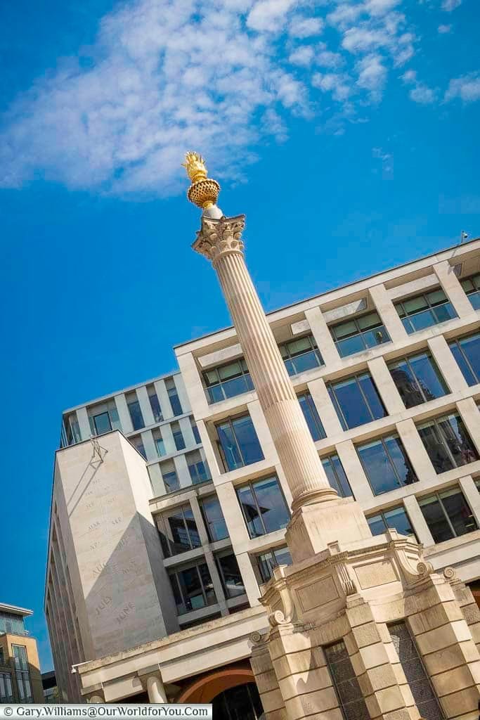 The Paternoster Square column, topped with flaming copper urn, in front of the London Stock Exchange