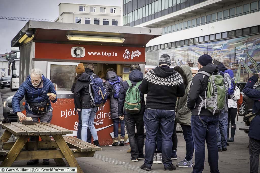 A queue of people at a hotdog vendors cabin in central reykjavik, iceland