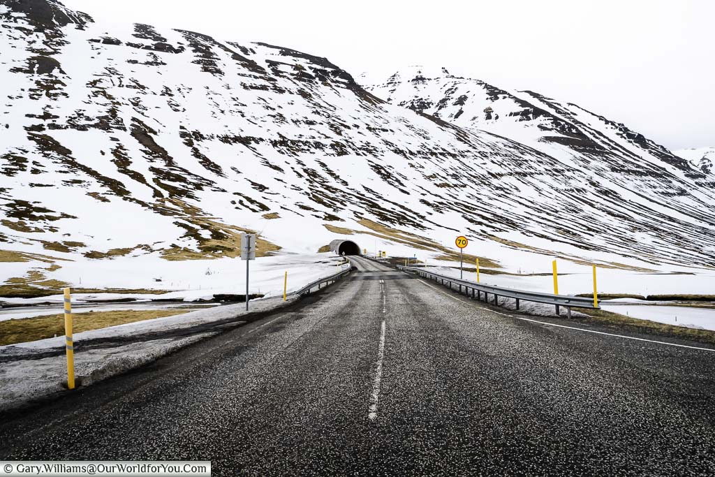 A section of Route 76 that leads into a tunnel through a mountain range in Northern Iceland