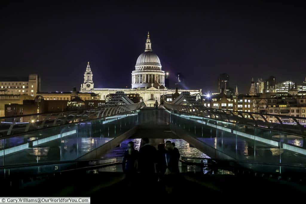 The view, at night, of St Paul's Cathedral from the Tate modern gallery looking across the Millennium Bridge, London, England, UK
