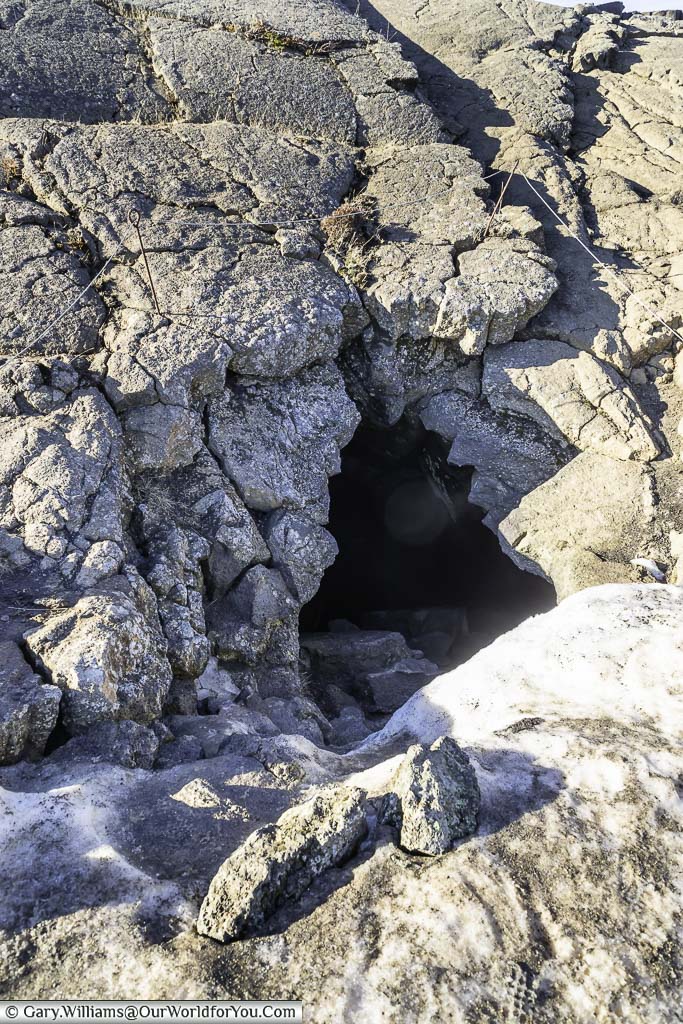 A hole in the ground leading to the Grjótagjá cave in Iceland