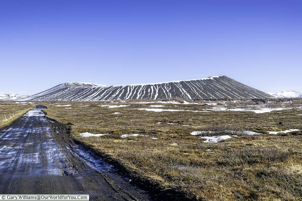 A muddy track through the volcanic soil leading to the Hverfjall Crater in Iceland