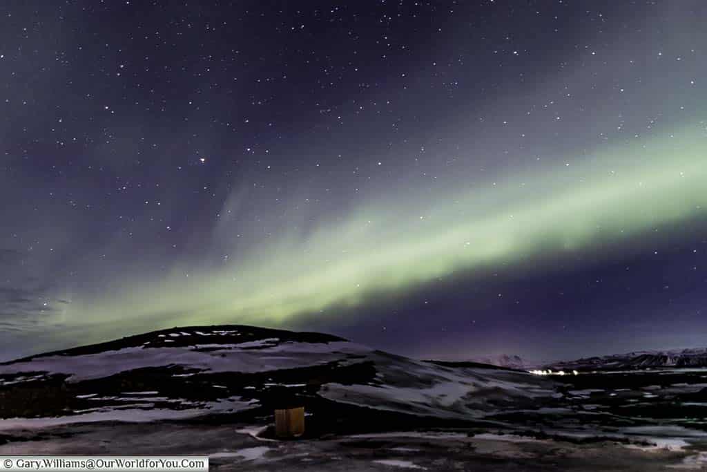 The Northern lights in full display on a star-filled night over the landscape of Reykjahlíð in Eastern Iceland, sights to see in iceland, places to visit in iceland, visit eastern iceland, visit iceland