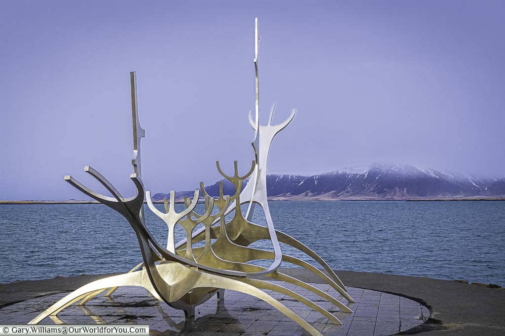 A conceptualstainless steel sculpture of a Viking boat on the water's edge in Reykjavik, Iceland.