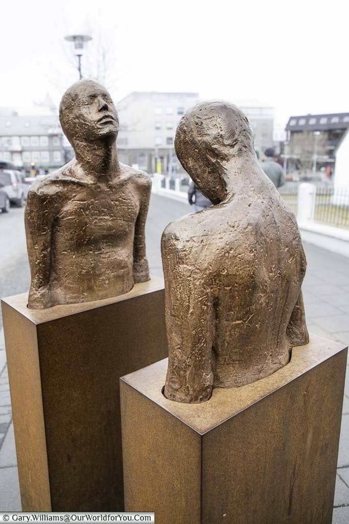 Two bronze figures set in rectangular blocks from the tourso down in the centre of reykjavik, iceland