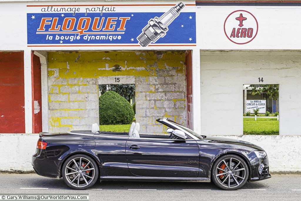 Our Audi RS5 convertible, with the roof down, in front of the pits at the disused historic race track of Circuit Reims-Gueux in the Champagne Region of France