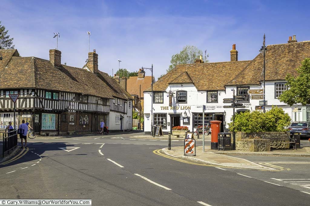 The crossroads at Lenham village square in Kent featuring historic buildings including the Red Lion pub