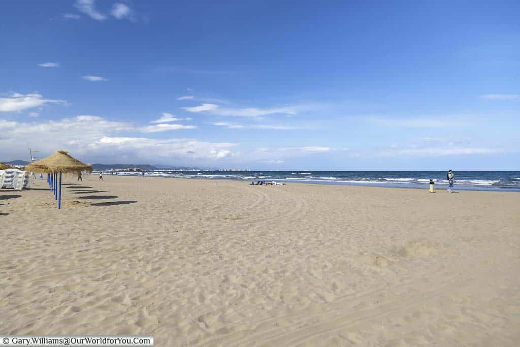 The golden sands and blue sky of the Malvarrosa Beach, Valencia, Spain