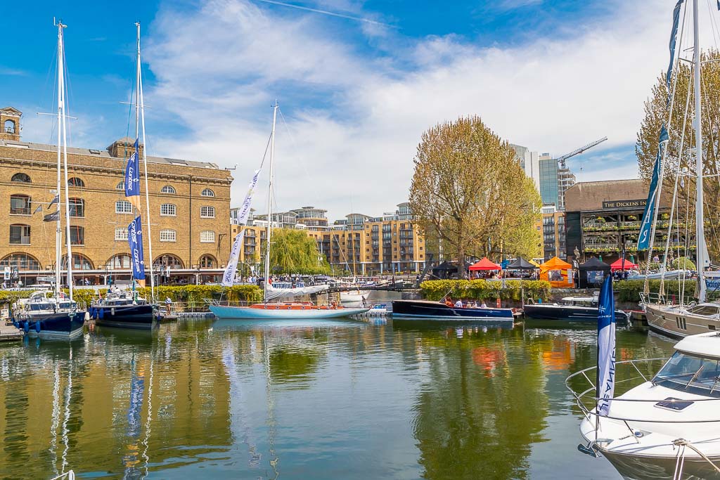 Sailing boats moored in a small marina at St Katharine Docks, a tranquil oasis a stone's throw from Tower Hill underground station.
