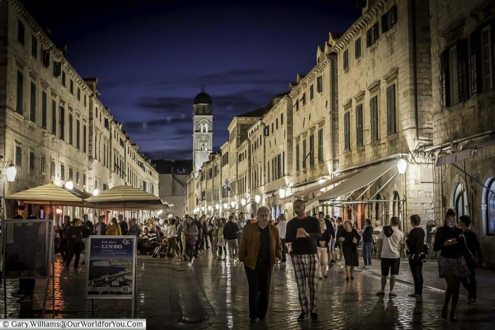 People walking along the stradum, the main thoroughfare in dubrovnik's old town at night