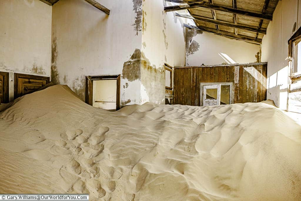 Sand dunes in the buildings of Kolmanskop, Namibia
