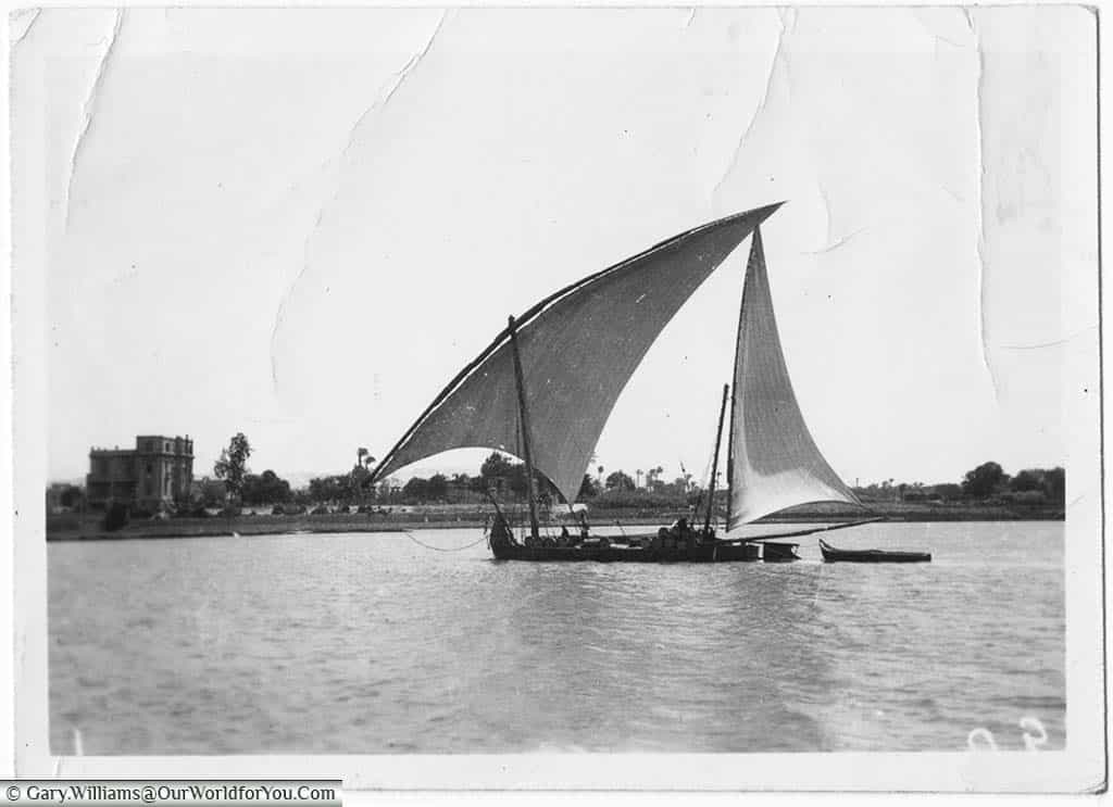 A sailing barge, known as a Felucca, making its way down the Nile.
