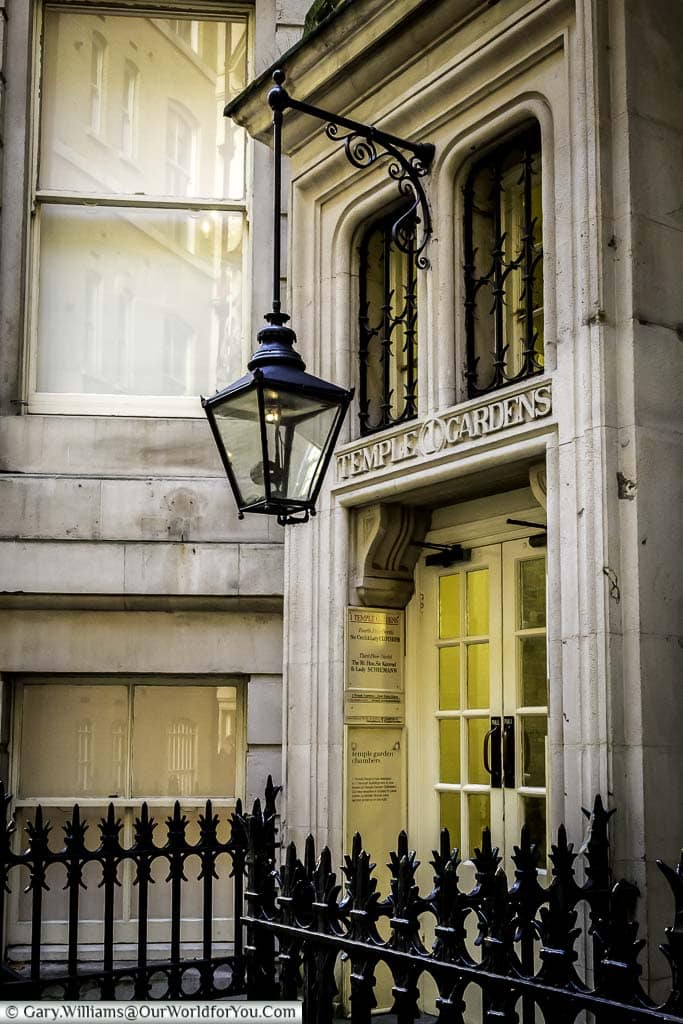 An original gas lantern hanging in front of a stone entrance to a building in middle temple identified as number one temple gardens.