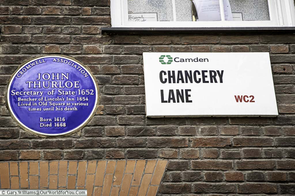 A modern street sign for Chancery Lane in the London borough of Camden WC2 next to a Blue Plaque for John Thurloe - Secretary of State - 1652