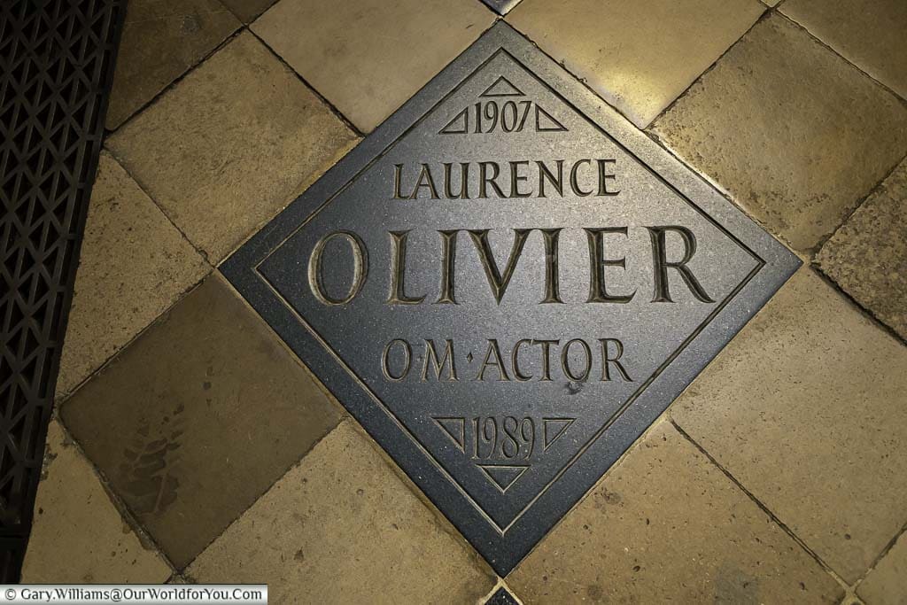 The memorial stone for Laurence Olivier in the poets corner section of westminster abbey in london