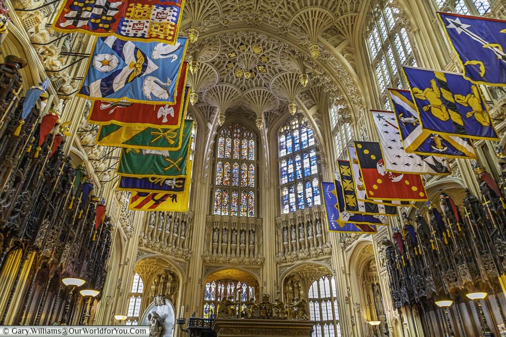 Flags hanging below the fan ornate vaulted ceiling of the lady chapel inside westminster abbey in london