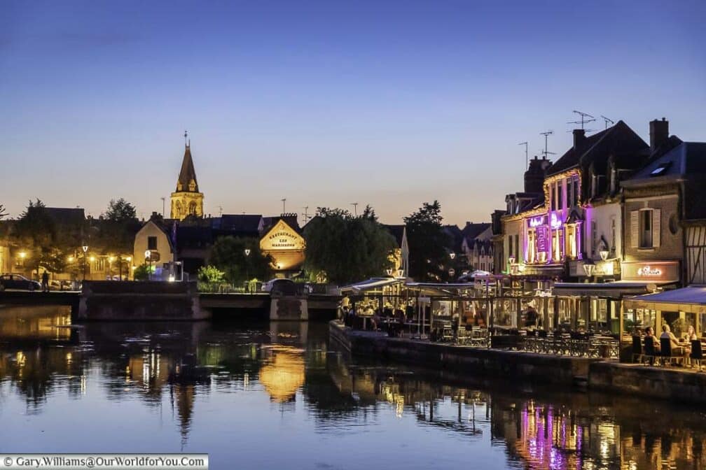 The quayside in the centre of amiens, france, at dusk, with restaurants lining one side
