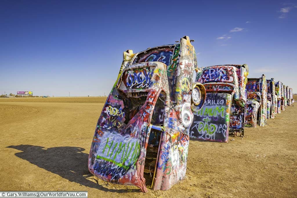Cadillac Ranch, A row of partly sunken graffitied car shells in a field outside Amarillo, Texas
