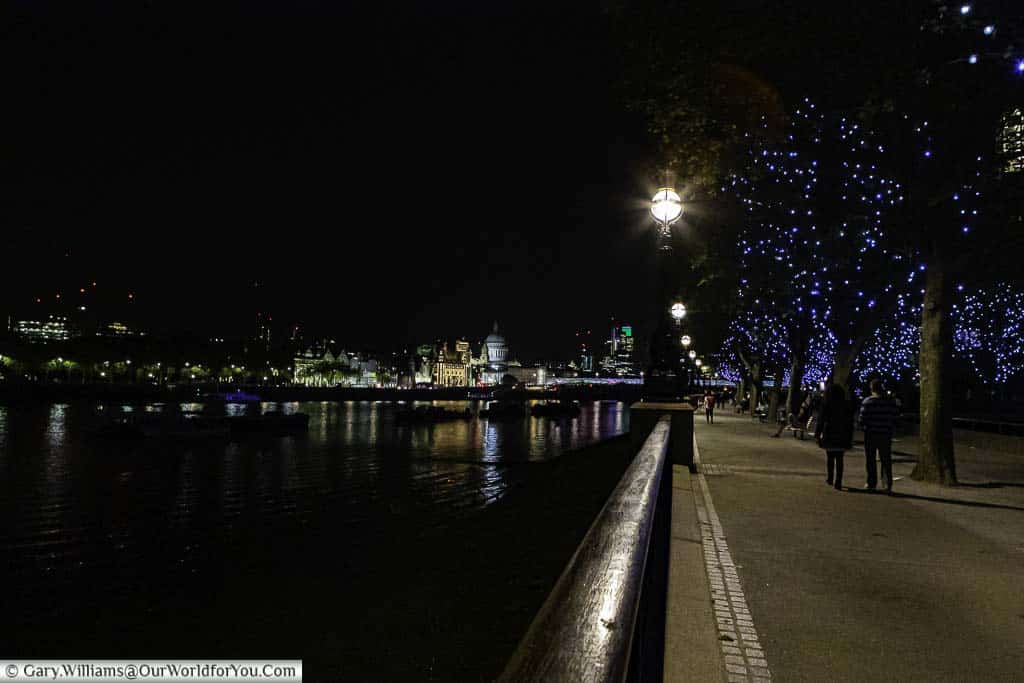 Strolling along the Southbank of the River Thames in London at night