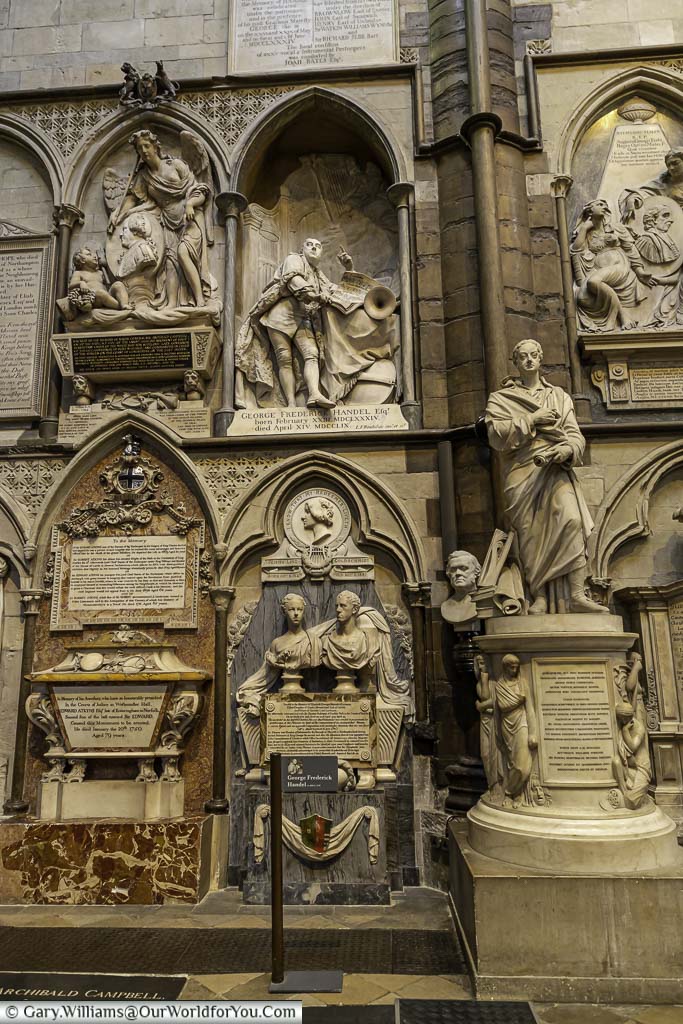 The memorial wall in poet’s corner of westminster abbey featuring statues and busts of notable individuals including the composer george frideric handel
