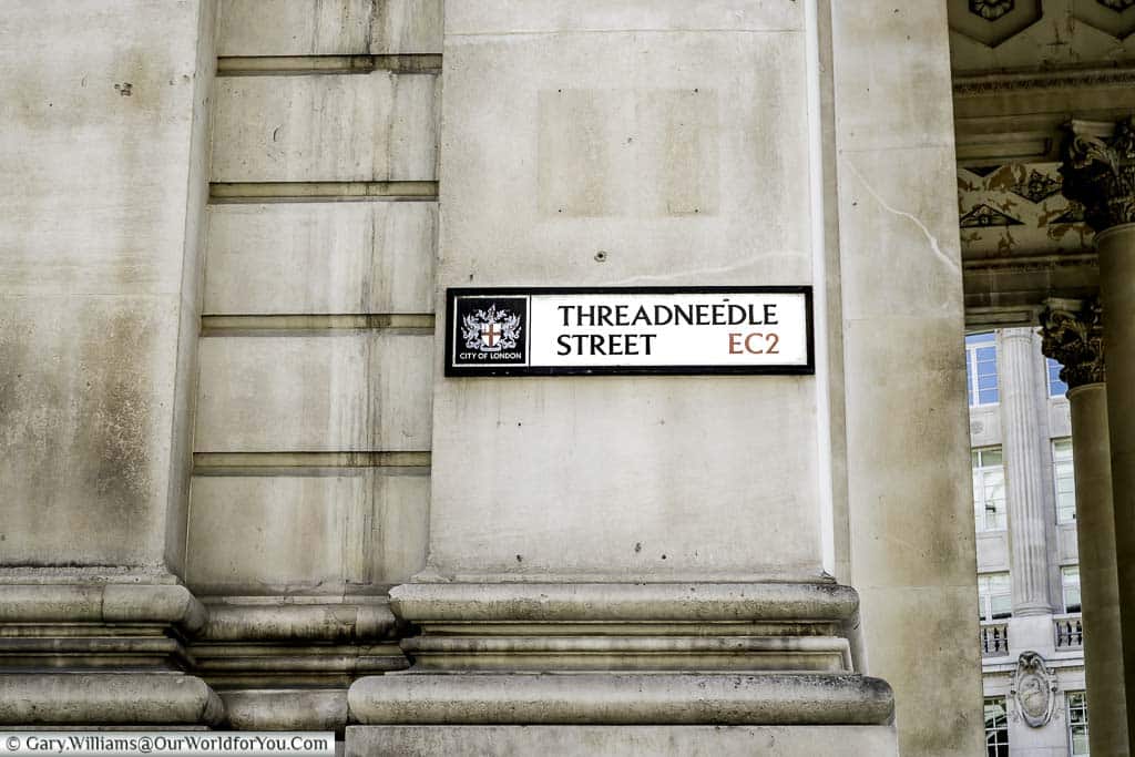 The street sign for Threadneedle Street attached to the Royal Exchange building in the City of London