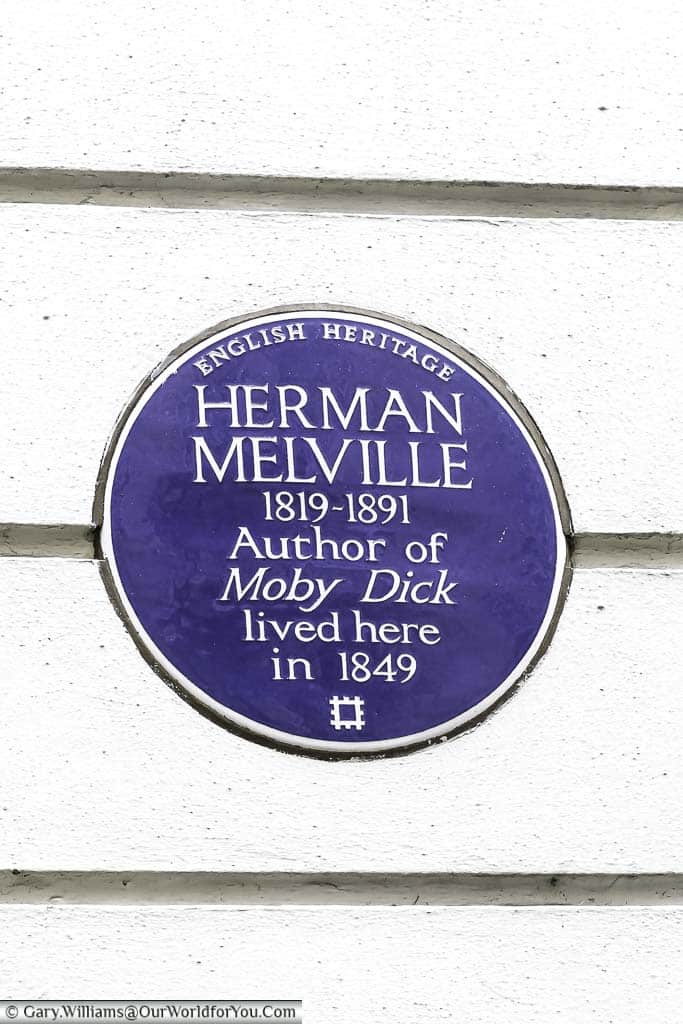 A close-up of a historic Blue Place to Herman Meville, author of Moby Dick, who lived in this building in 1849