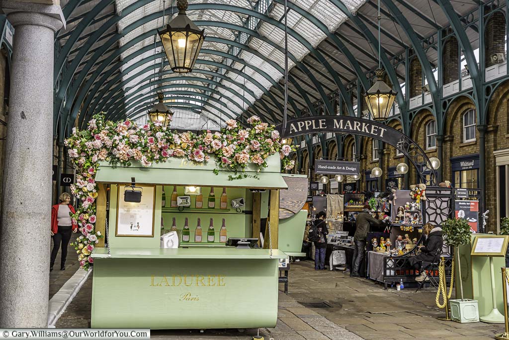 The pretty little pale green cabin for the ladurée patisserie cafe at the entrance to the apple market in london's covent garden