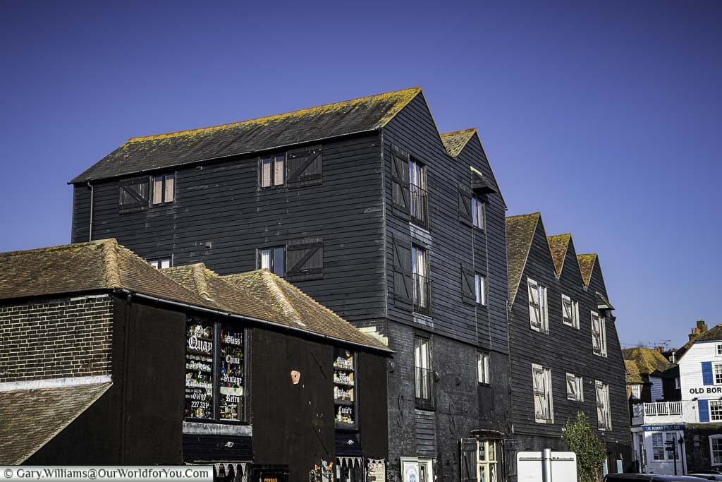The black former fishermen's warehouses on the quayside that now house curio and antique shops in rye, east sussex