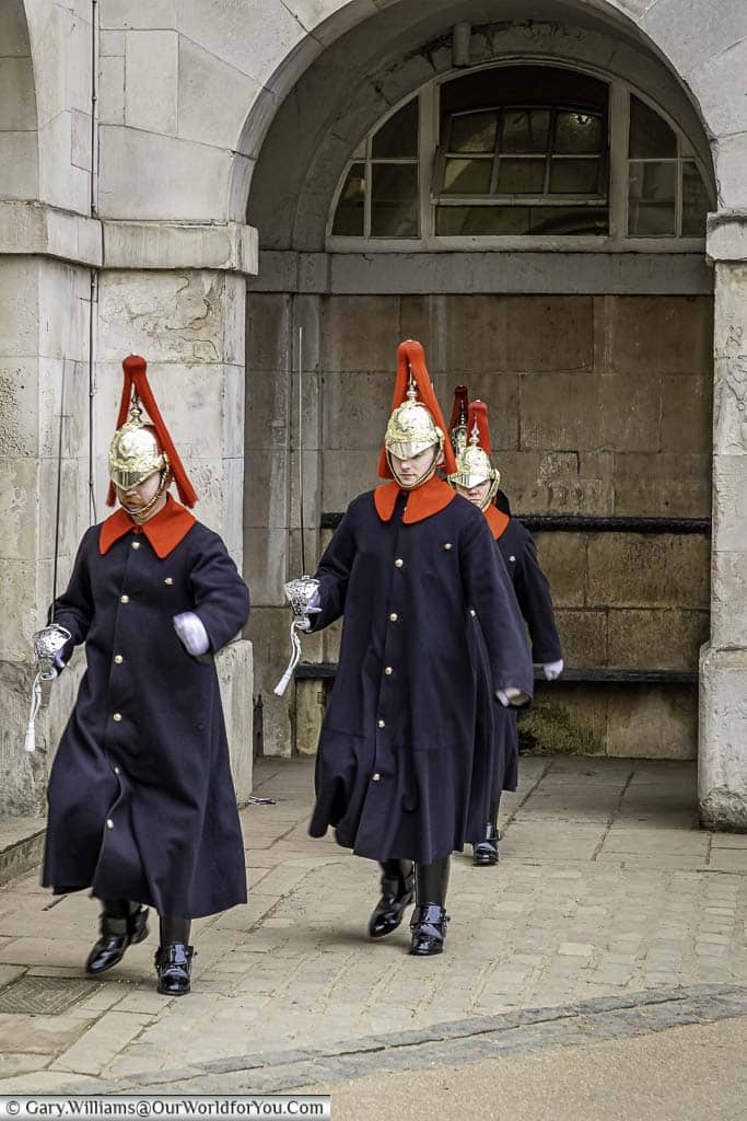 Three sentries from the Blues and Royals, march toward us, leaving one in position, during the changing of the guard.