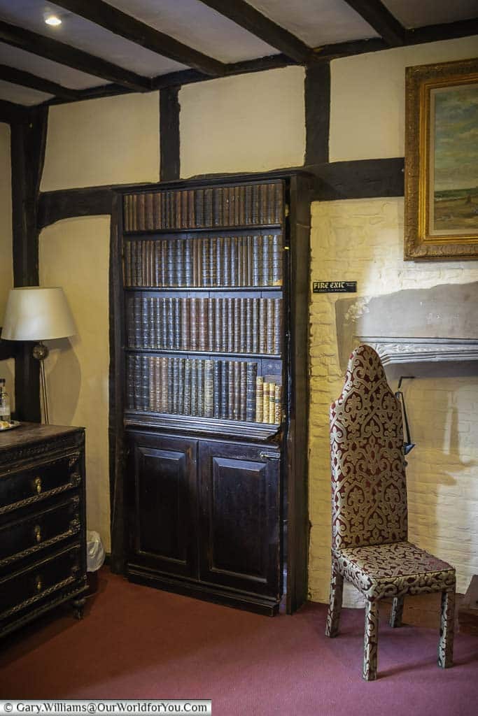 A hidden door disguised as a bookcase in one of the room in the mermaid inn in rye, east sussex