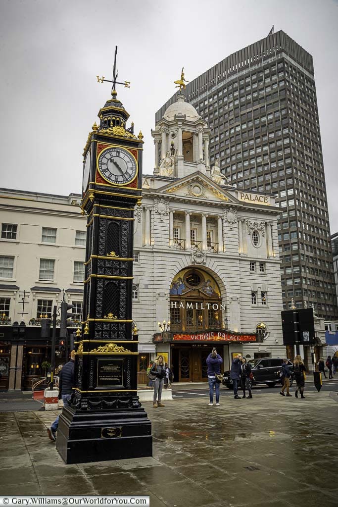 The black and gold cast-iron clock tower known as 'Little Ben' in front of the Victoria Palace Theatre in London's Victoria.