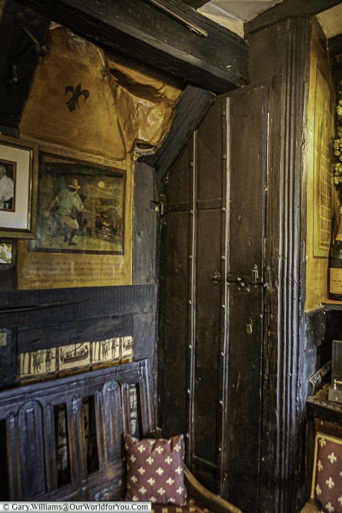 A secret dark wooden door in the corner of the medieval Giants' fireplace bar that has been in place since the time of the English Reformation