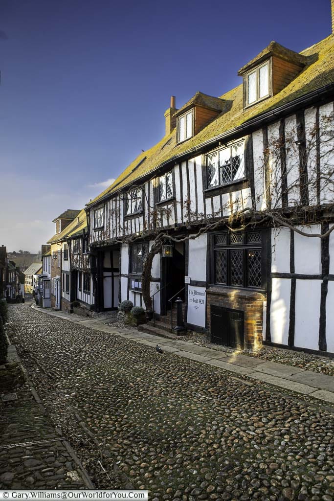 Late afternoon outside the historic mermaid inn on the cobbled mermaid street on a clear winter's day in rye, east sussex
