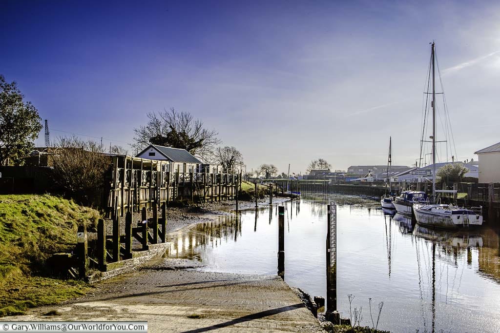 Boats moored up on the River Brede which runs through Rye, East Sussex, on a bright winter's day.