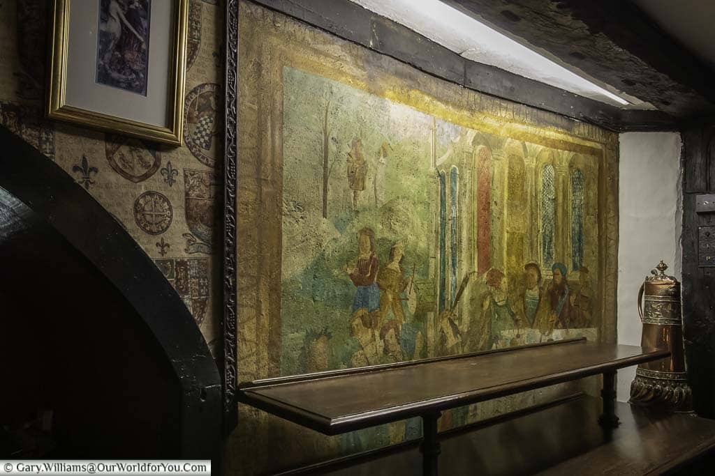 A hand-painted mural on the wall of the Mermaid Inn said to depict 15/16th-century scene of Shakespearian players performing