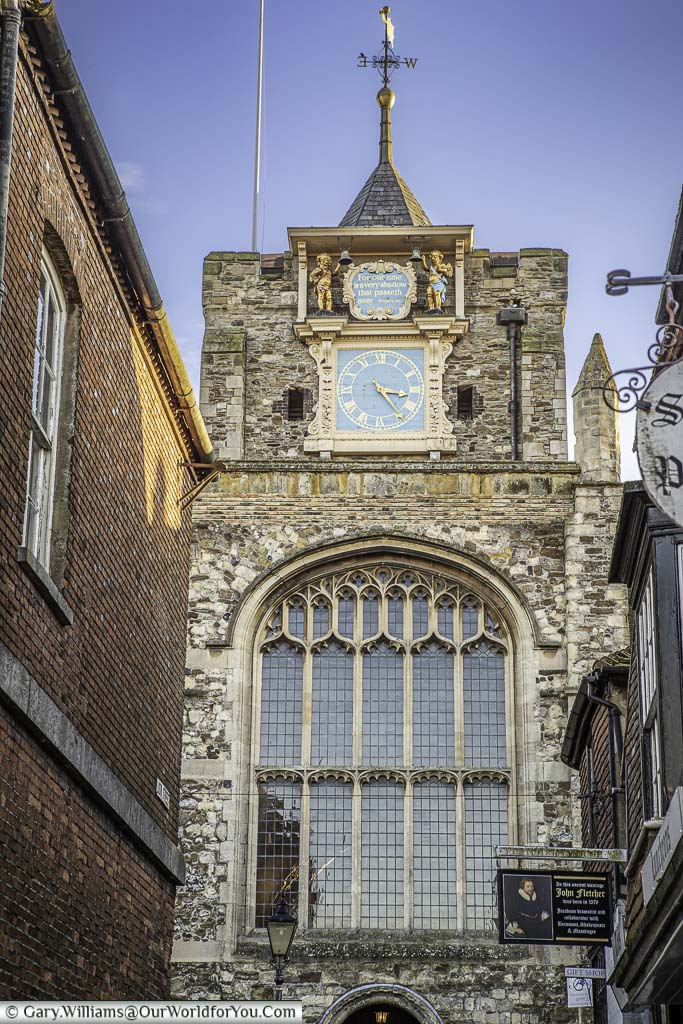 The church tower of St Mary's the Virgin, with its large glass window and clock face in rye, east sussex