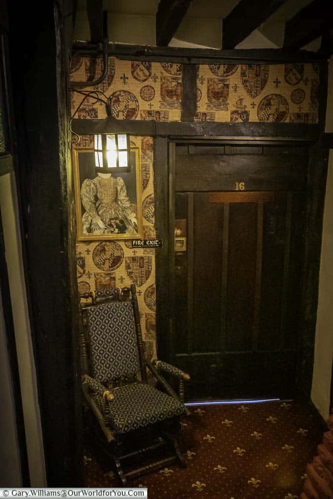 A small rocking chair that's said to be haunted in a hallway in the Mermaid Inn in rye, east sussex