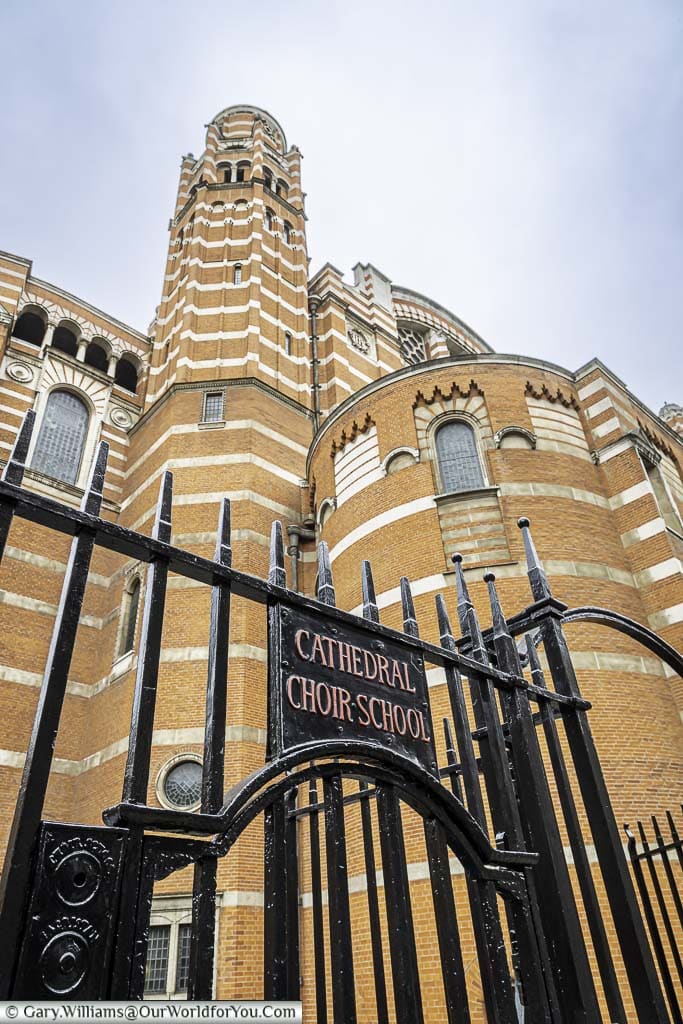 The gate to the Cathedral Choir School, with the bell tower of Westminster Cathedral in the background.