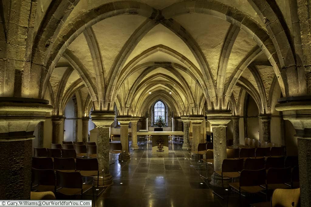 A chapel beneath the vaulted arches of the medieval crypt of rochester cathedral in kent