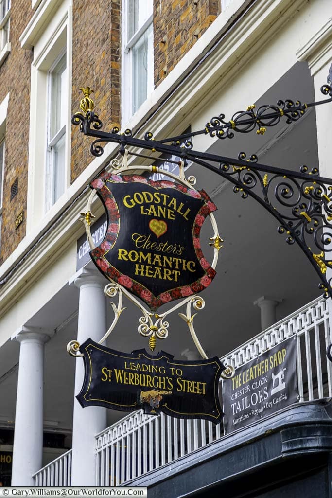 An ornate sign hanging from the eastgate rows leading you toward the hidden gem that is Godstall lane