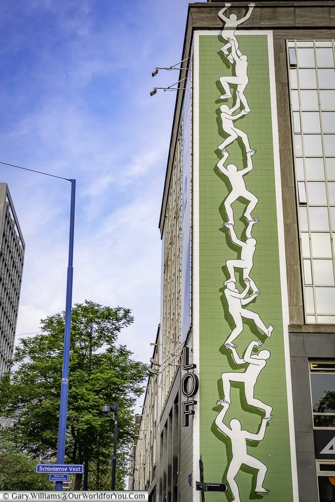 A stencil of a human ladder climbing the outside of a multi-storey building in rotterdam in the netherlands