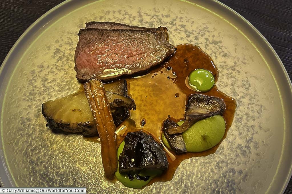 A close-up of the Hereford sirloin of beef with baby carrot, Madeira and mushroom main meal at the forge restaurant in the hotel indigo chester