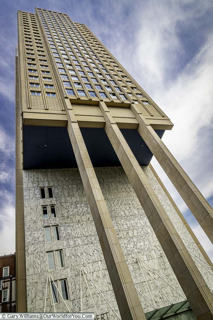 A 60s skyscraper that appears to be partially on stilts in central rotterdam