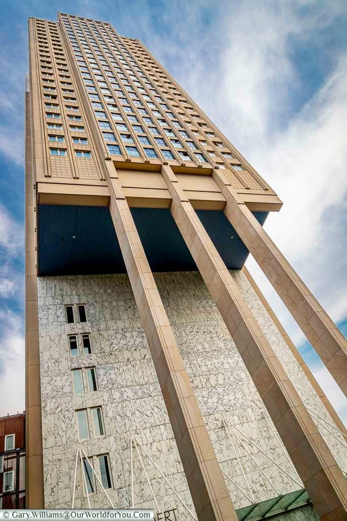 A 60s skyscraper that appears to be partially on stilts in central rotterdam